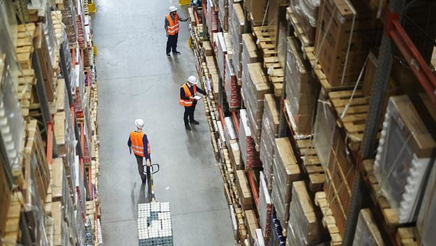 DSV employees are inside the large rack-filled DSV warehouse