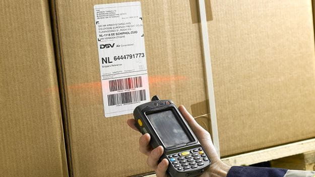 A DSV employee is equipped with a barcode scanner to do value-added services such as quality inspections, labelling, and packing.