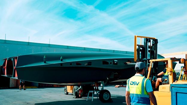 A DSV employee is transporting the items on electric forklifts.