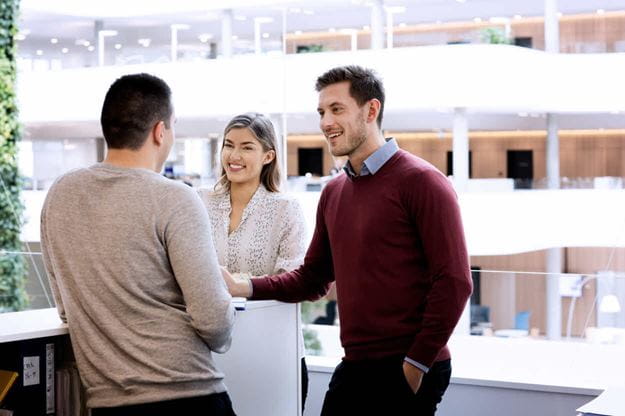 Group of DSV employees talking in the headquarters of DSV in Hedehusene