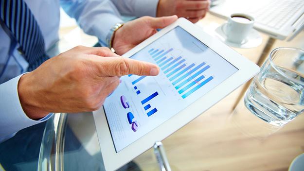 This image shows a person using a tablet that displays the data represented in the graph.