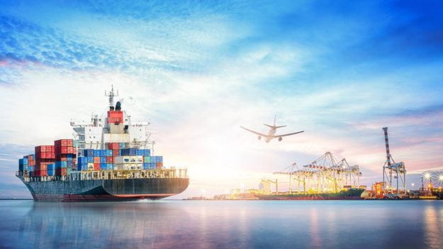 Container ship at port with gantry cranes and departing airplane.