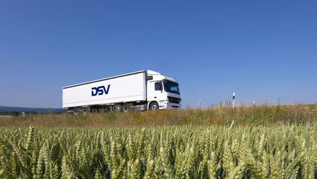DSV Linehaul truck driving past a wheatflield