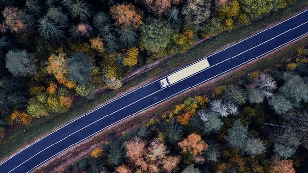 Truck driving through the forest