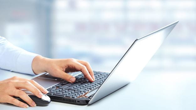 Eine Person, die mit einem Laptop arbeitet