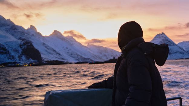 Person with sea and mountain panorama in the background