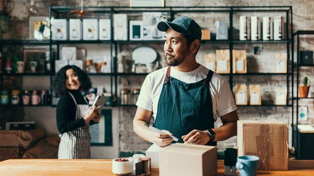 Two workers packing parcels