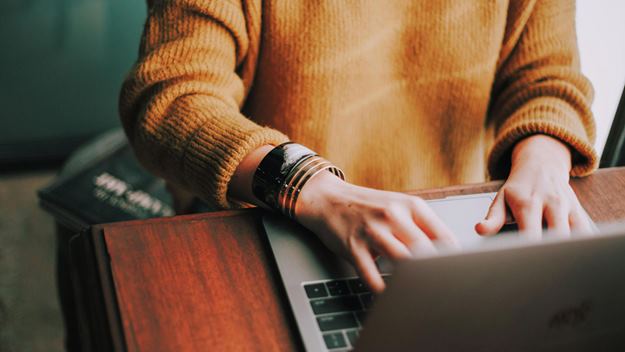 A woman typing on her laptop