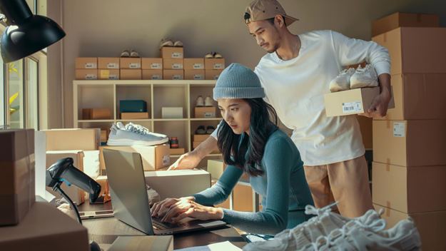 A woman and a man packing orders in an office