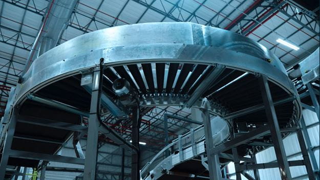 A large, curved conveyor system in an industrial facility