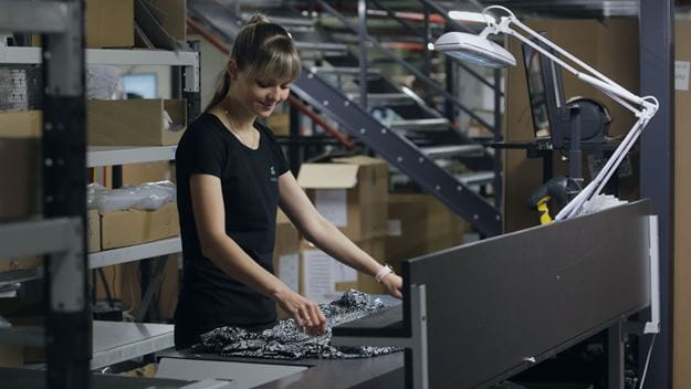 Female warehouse worker classifying returns