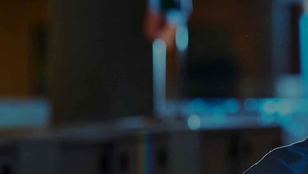 A man wearing a headset working at his desk in an office environment. One image is split into 6 separate images showing a part of the image