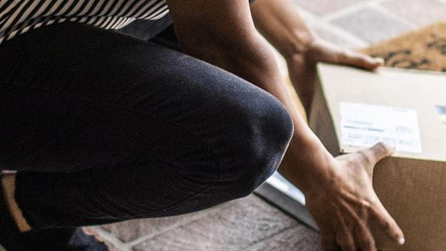 Woman receiving e-commerce package at doorstep