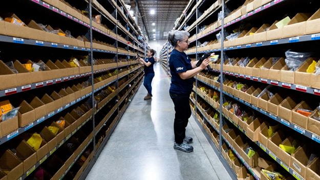 Warehouse worker at picking area inside warehouse