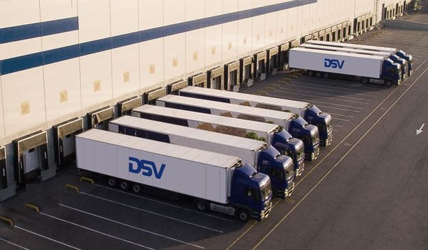 DSV transporters in front of a warehouse