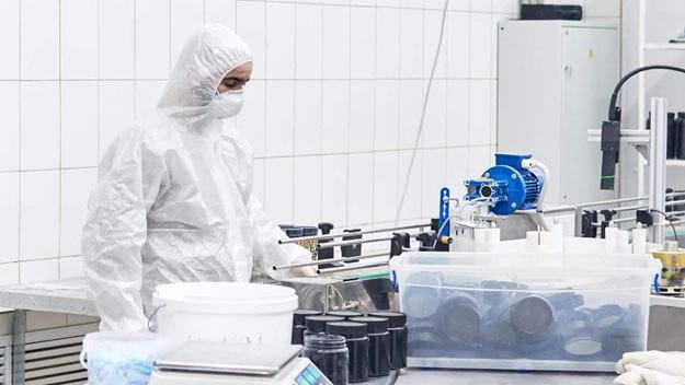 Pharma warehouse worker conducting a process in a compliant environment