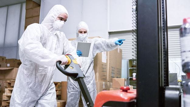 Healthcare personnel wearing masks and safety suit