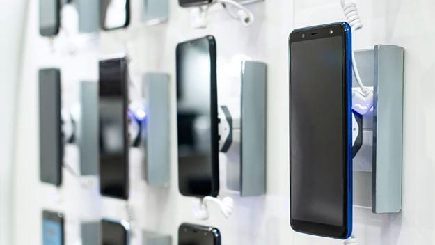Mobile phones hanging on a wall for display