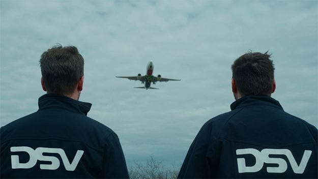 dsv transport and logistics two dsv employees watch air plane