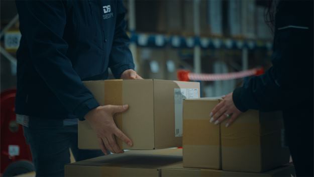 dsv transport and logistics dsv employees put boxes down