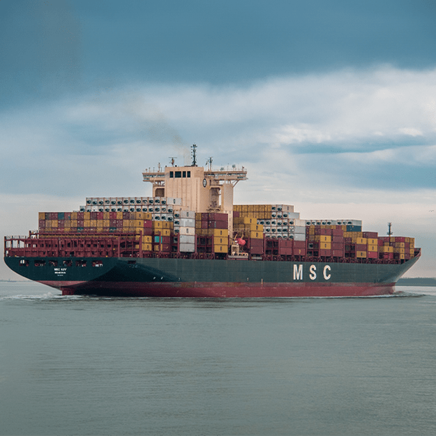 Large container ship labeled 'MSC' fully loaded with shipping containers stacked high