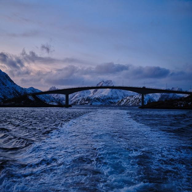 bridge over water near mountains