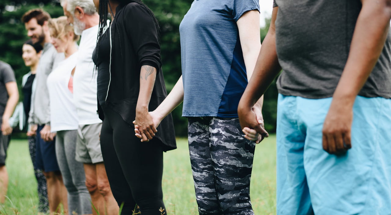 Community holding hands standing together